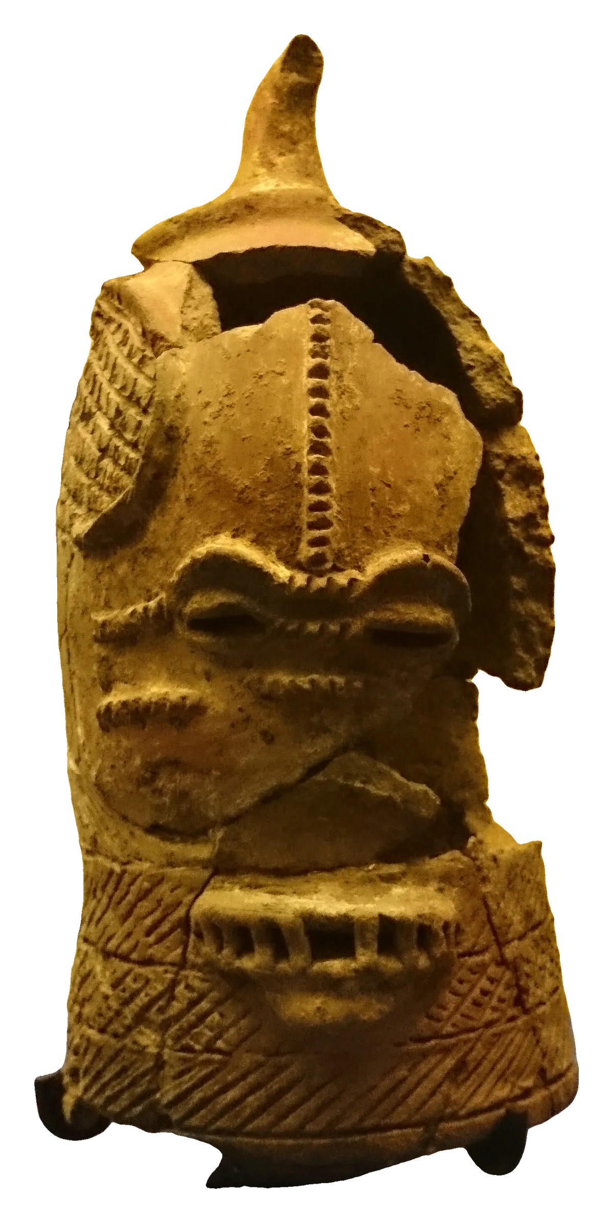 A hollow terracotta head with incised bands across the face and a small animal figure on top.
